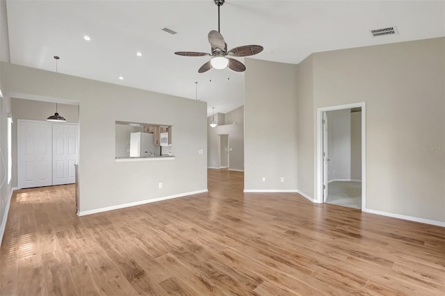 4539 Cabbage Key Ter, Bradenton, FL 34203 - unfurnished living room with a ceiling fan, light wood-style floors, high vaulted ceiling, and recessed lighting