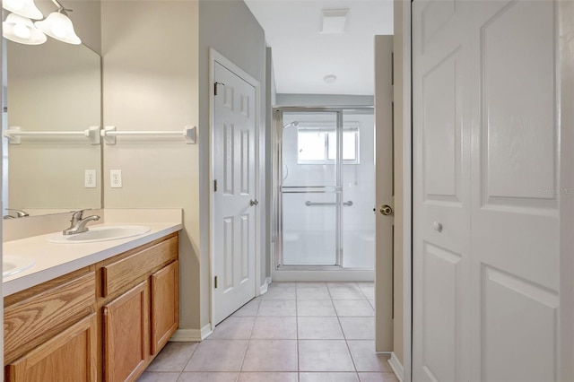4539 Cabbage Key Ter, Bradenton, FL 34203 - full bathroom with double vanity, a closet, a stall shower, and tile patterned floors