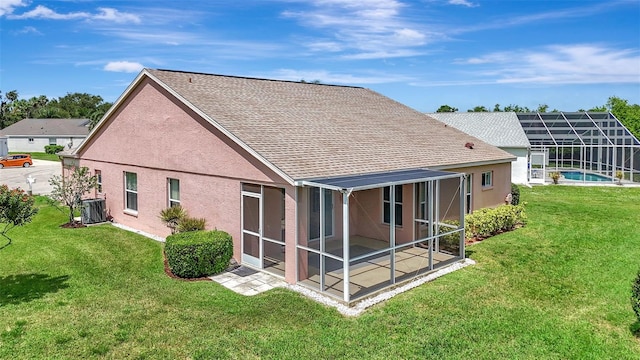 4539 Cabbage Key Ter, Bradenton, FL 34203 - rear view of house with a lawn, roof with shingles, stucco siding, an outdoor pool, and a lanai