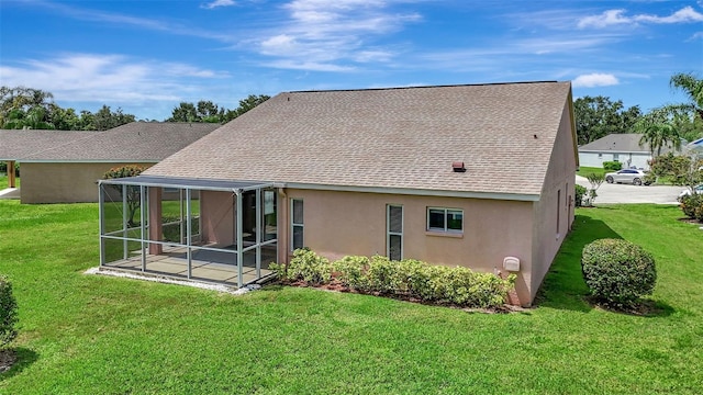4539 Cabbage Key Ter, Bradenton, FL 34203 - rear view of property featuring a sunroom, a shingled roof, stucco siding, and a yard