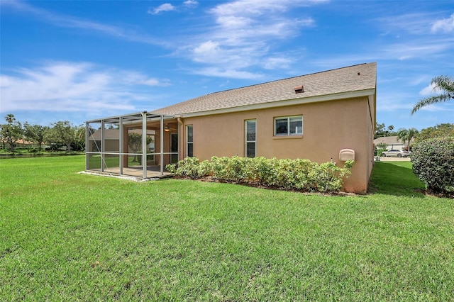 4539 Cabbage Key Ter, Bradenton, FL 34203 - back of property featuring stucco siding, a yard, and a sunroom