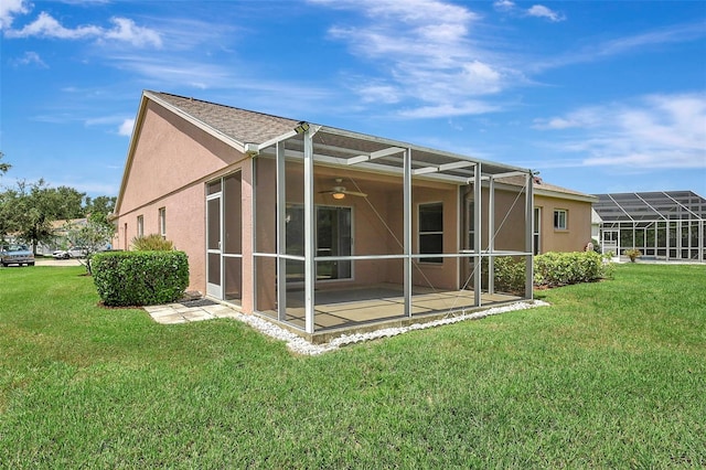 4539 Cabbage Key Ter, Bradenton, FL 34203 - rear view of property with stucco siding, a lawn, a patio area, and ceiling fan