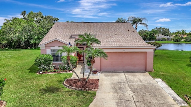 4539 Cabbage Key Ter, Bradenton, FL 34203 - view of front of home with concrete driveway, a garage, a water view, stucco siding, and a front lawn