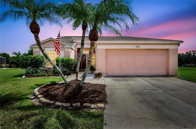 4539 Cabbage Key Ter, Bradenton, FL 34203 - single story home with concrete driveway, a garage, stucco siding, and a yard
