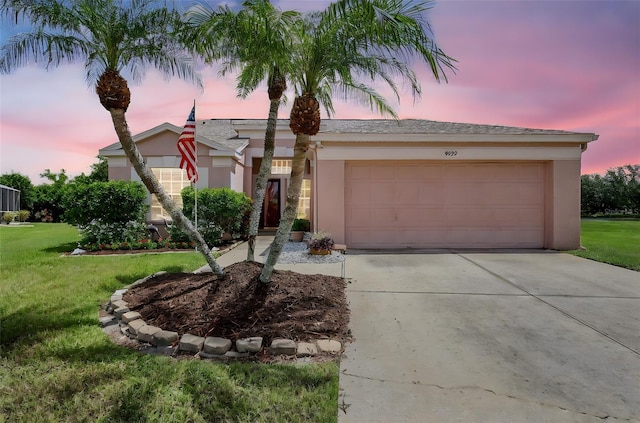 4539 Cabbage Key Ter, Bradenton, FL 34203 - ranch-style home with driveway, a garage, a yard, and stucco siding