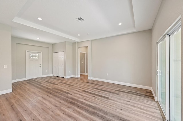5534 Fairlane Dr, North Port, FL 34288 - unfurnished bedroom featuring light wood-style flooring, recessed lighting, and a raised ceiling