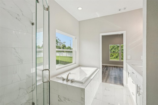 5534 Fairlane Dr, North Port, FL 34288 - bathroom featuring marble finish flooring, vanity, a bath, and a marble finish shower