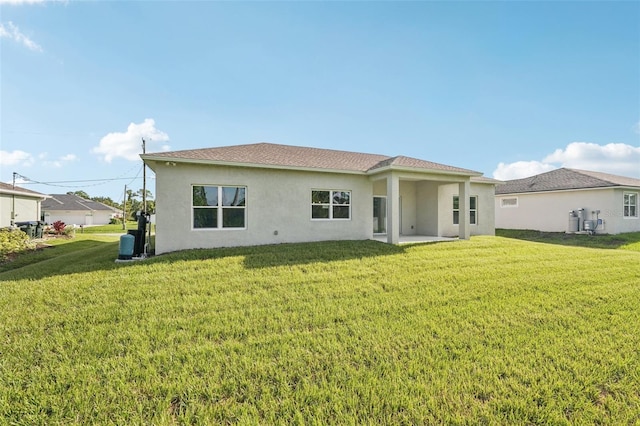5534 Fairlane Dr, North Port, FL 34288 - back of house with stucco siding and a yard