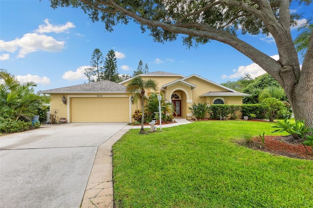 6118 56th Ter E, Bradenton, FL 34203 - view of front of home with stucco siding, an attached garage, driveway, and a front lawn