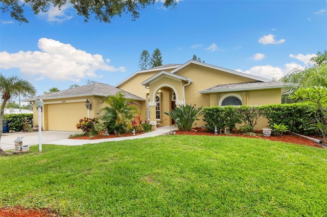 6118 56th Ter E, Bradenton, FL 34203 - mediterranean / spanish-style home with stucco siding, an attached garage, a front lawn, and concrete driveway