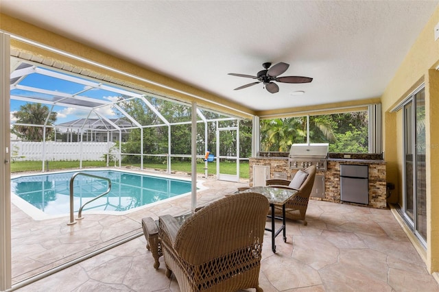 6118 56th Ter E, Bradenton, FL 34203 - view of pool featuring exterior kitchen, a patio area, a ceiling fan, and glass enclosure