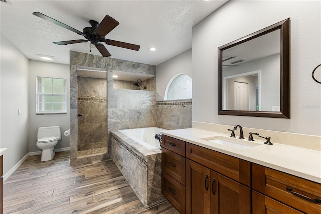 6118 56th Ter E, Bradenton, FL 34203 - full bath featuring vanity, a bath, a walk in shower, wood finished floors, and a ceiling fan