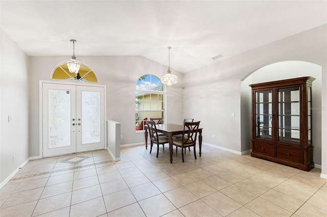 6118 56th Ter E, Bradenton, FL 34203 - foyer featuring light tile patterned floors, arched walkways, lofted ceiling, french doors, and a chandelier