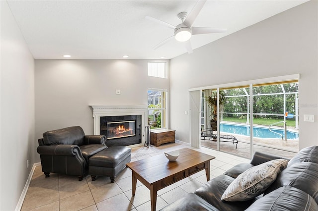 6118 56th Ter E, Bradenton, FL 34203 - living area with light tile patterned floors, ceiling fan, a high end fireplace, a high ceiling, and recessed lighting