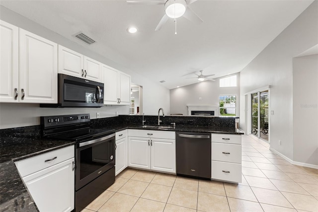 6118 56th Ter E, Bradenton, FL 34203 - kitchen featuring black appliances, a ceiling fan, vaulted ceiling, a peninsula, and a fireplace
