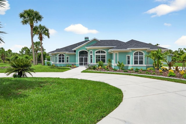 2555 Pear St, Port Charlotte, FL 33948 - ranch-style home featuring a front lawn, stucco siding, a chimney, and a shingled roof