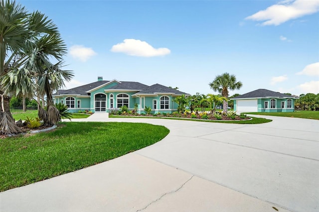 2555 Pear St, Port Charlotte, FL 33948 - ranch-style home featuring curved driveway, a front yard, and a garage