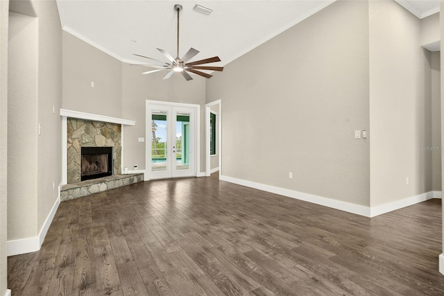 2555 Pear St, Port Charlotte, FL 33948 - unfurnished living room featuring dark wood finished floors, ceiling fan, a fireplace, ornamental molding, and french doors