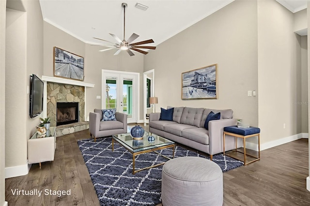 2555 Pear St, Port Charlotte, FL 33948 - living room featuring wood finished floors, ceiling fan, a stone fireplace, ornamental molding, and french doors