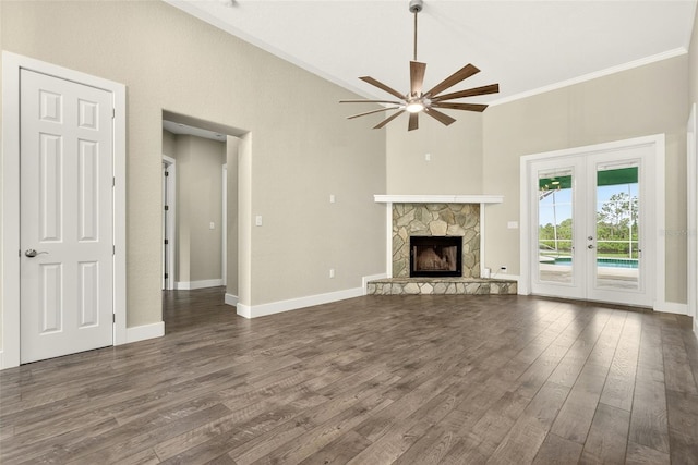 2555 Pear St, Port Charlotte, FL 33948 - unfurnished living room featuring ornamental molding, a ceiling fan, dark wood-style flooring, french doors, and a stone fireplace