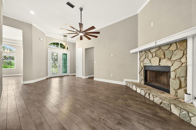 2555 Pear St, Port Charlotte, FL 33948 - unfurnished living room with crown molding, a ceiling fan, a stone fireplace, and hardwood / wood-style floors