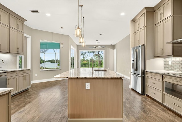 2555 Pear St, Port Charlotte, FL 33948 - kitchen featuring appliances with stainless steel finishes, a kitchen island, backsplash, wood-type flooring, and recessed lighting