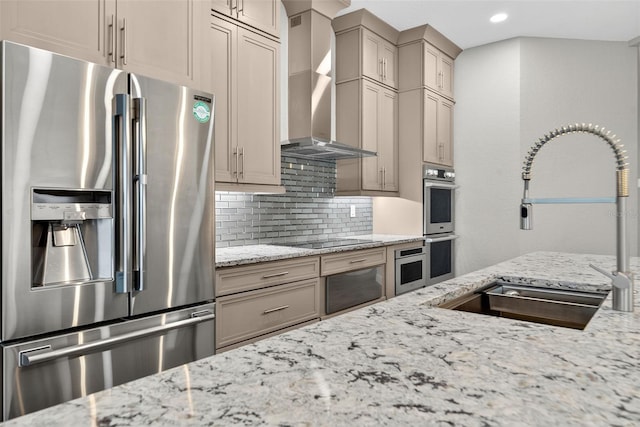 2555 Pear St, Port Charlotte, FL 33948 - kitchen with appliances with stainless steel finishes, wall chimney range hood, decorative backsplash, light stone counters, and recessed lighting