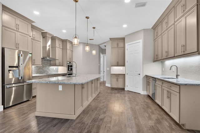 2555 Pear St, Port Charlotte, FL 33948 - kitchen featuring appliances with stainless steel finishes, wall chimney range hood, tasteful backsplash, light stone countertops, and dark wood-style flooring