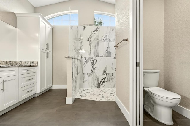 2555 Pear St, Port Charlotte, FL 33948 - bathroom featuring a walk in shower, a textured wall, vanity, and tile patterned floors