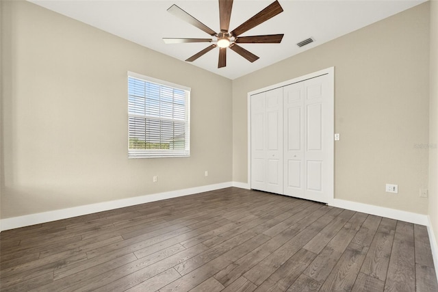 2555 Pear St, Port Charlotte, FL 33948 - unfurnished bedroom featuring dark wood finished floors, a closet, and a ceiling fan