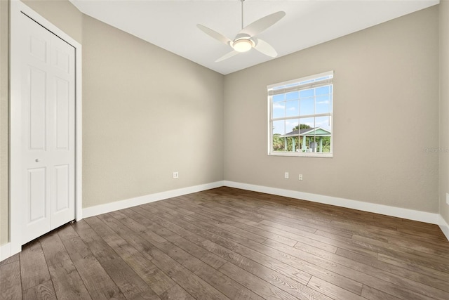 2555 Pear St, Port Charlotte, FL 33948 - unfurnished bedroom featuring dark wood finished floors and ceiling fan