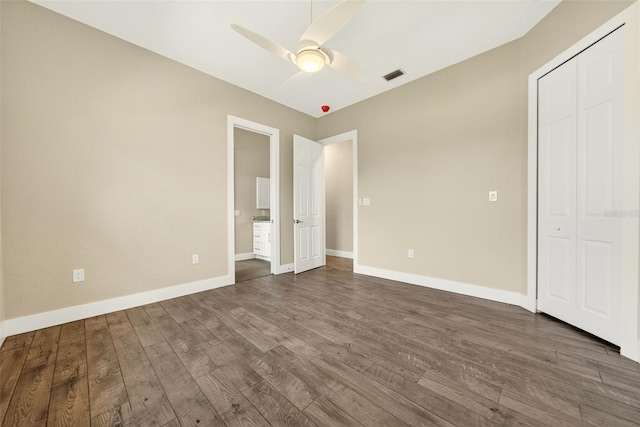 2555 Pear St, Port Charlotte, FL 33948 - unfurnished bedroom with dark wood-style floors, a ceiling fan, ensuite bath, and a closet