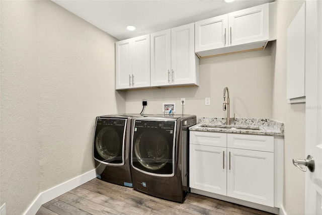 2555 Pear St, Port Charlotte, FL 33948 - laundry room featuring washing machine and dryer, light wood-style floors, cabinet space, and recessed lighting