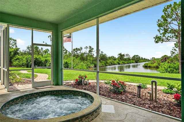2555 Pear St, Port Charlotte, FL 33948 - sunroom featuring a jacuzzi, a water view, and view of scattered trees