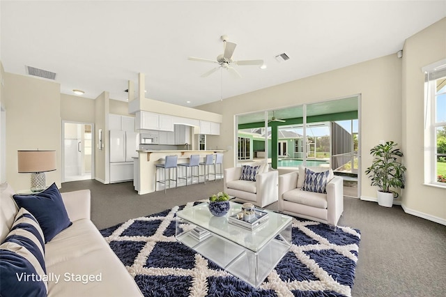 2555 Pear St, Port Charlotte, FL 33948 - living area featuring a ceiling fan and dark carpet