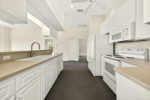 2555 Pear St, Port Charlotte, FL 33948 - kitchen with white appliances, dark colored carpet, white cabinets, ceiling fan, and recessed lighting