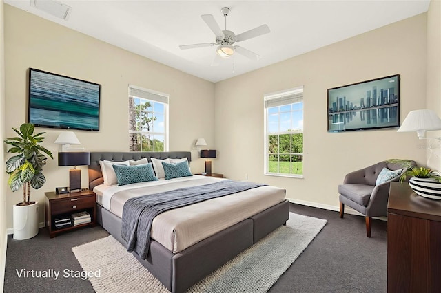 2555 Pear St, Port Charlotte, FL 33948 - bedroom with dark colored carpet, multiple windows, and a ceiling fan