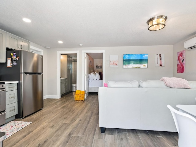544 Canal Rd, Sarasota, FL 34242 - living room with a wall unit AC, light wood finished floors, and recessed lighting