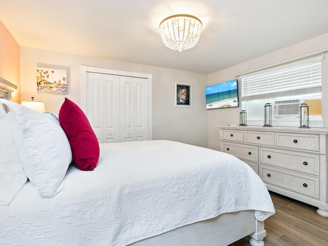544 Canal Rd, Sarasota, FL 34242 - bedroom featuring wood finished floors, a chandelier, a closet, and cooling unit