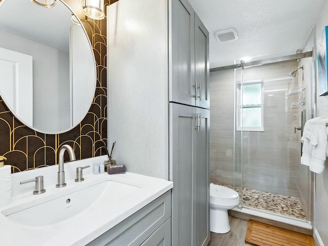 544 Canal Rd, Sarasota, FL 34242 - full bath featuring a stall shower, wood finished floors, vanity, and a textured ceiling