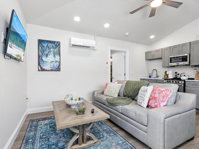 544 Canal Rd, Sarasota, FL 34242 - living area with a wall mounted air conditioner, ceiling fan, lofted ceiling, wood finished floors, and recessed lighting