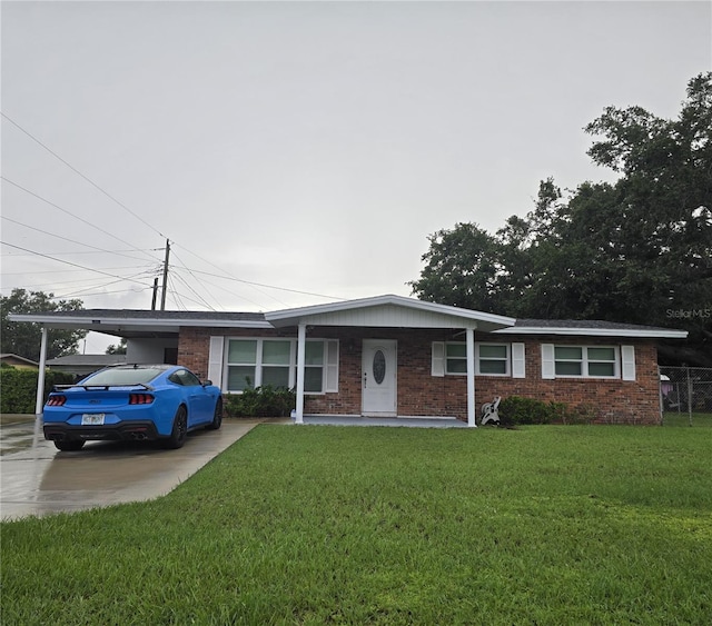 1903 4th Ave W, Palmetto, FL 34221 - ranch-style house featuring a front yard, brick siding, and concrete driveway