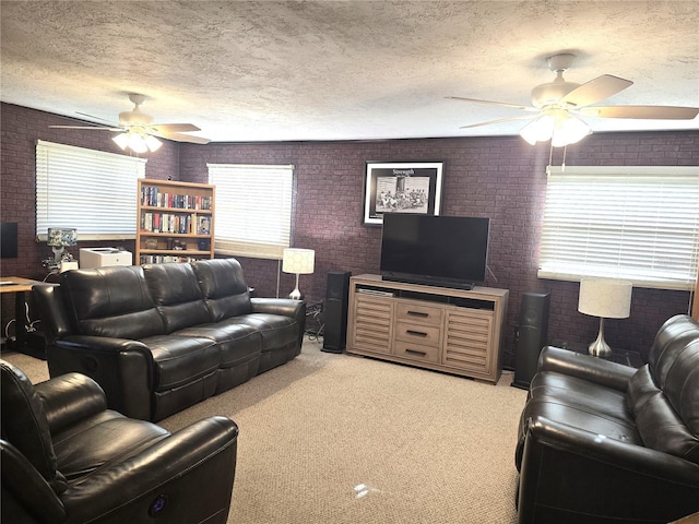 1903 4th Ave W, Palmetto, FL 34221 - living room featuring a ceiling fan, brick wall, a textured ceiling, and light carpet