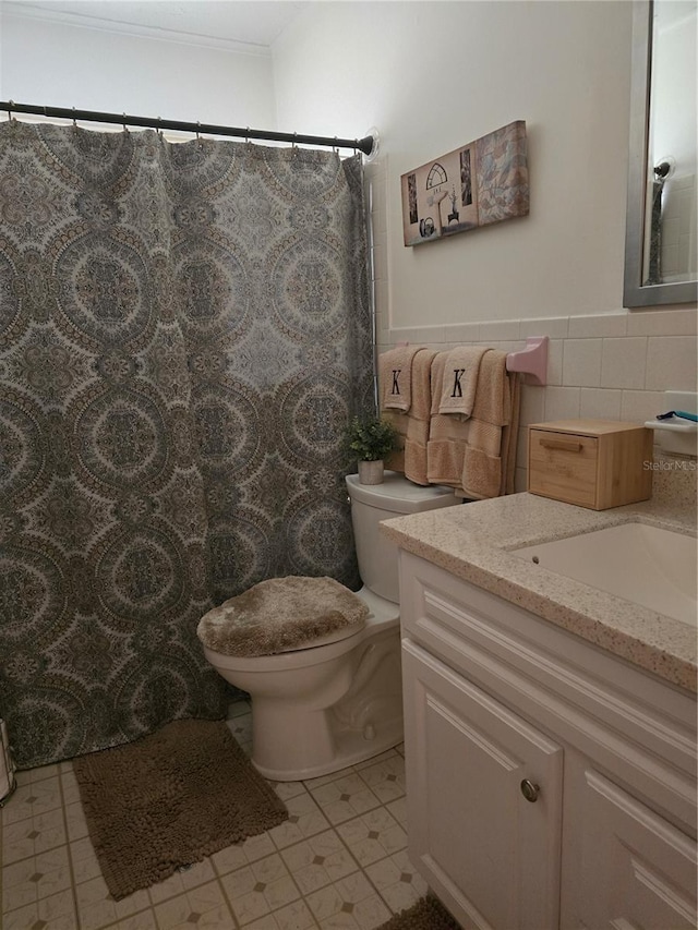 1903 4th Ave W, Palmetto, FL 34221 - bathroom featuring vanity, tile walls, curtained shower, tile patterned flooring, and a wainscoted wall