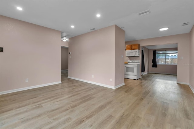 6439 Lafayette Rd, Bradenton, FL 34207 - unfurnished living room featuring light wood-type flooring and recessed lighting