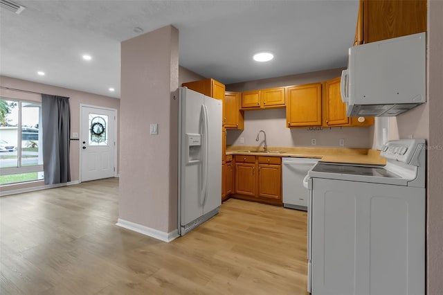 6439 Lafayette Rd, Bradenton, FL 34207 - kitchen featuring white appliances, light wood-type flooring, light countertops, recessed lighting, and brown cabinetry