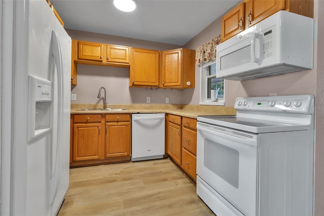 6439 Lafayette Rd, Bradenton, FL 34207 - kitchen featuring white appliances, light countertops, light wood-type flooring, and brown cabinets
