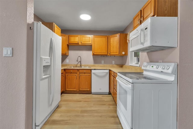6439 Lafayette Rd, Bradenton, FL 34207 - kitchen featuring white appliances, light wood finished floors, light countertops, and brown cabinets