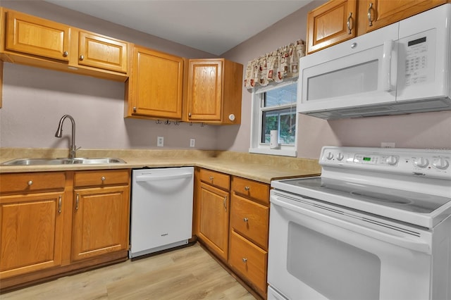 6439 Lafayette Rd, Bradenton, FL 34207 - kitchen with white appliances, light countertops, light wood finished floors, and brown cabinets