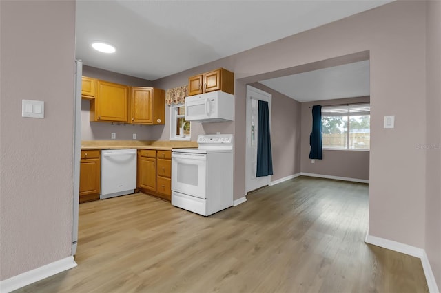 6439 Lafayette Rd, Bradenton, FL 34207 - kitchen featuring white appliances, light countertops, and light wood-type flooring